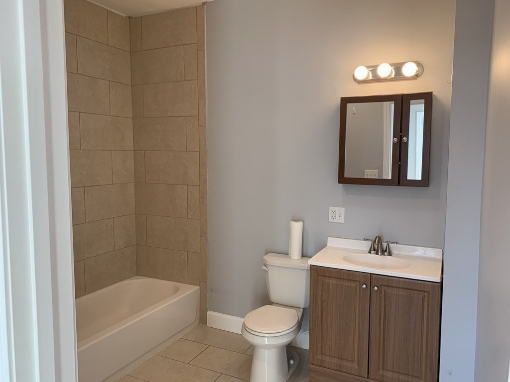 107 Chelsea Street, Unit 3 Boston, MA 02128 - Photo 12 of 15 a bathroom with a toilet sink and bathtub
