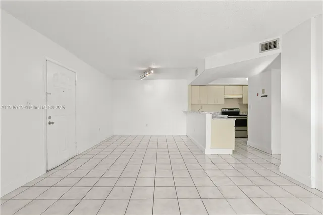 a view of a kitchen with white cabinets