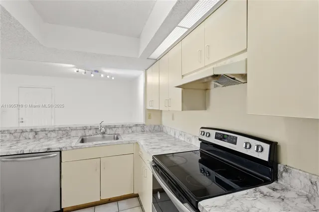 a kitchen with a stove a sink and a refrigerator