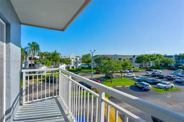 a view of a house with a deck and furniture