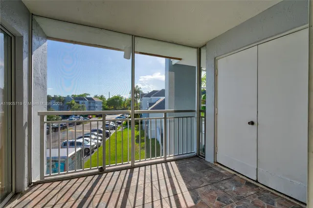 a view of a balcony with floor to ceiling windows with wooden floor