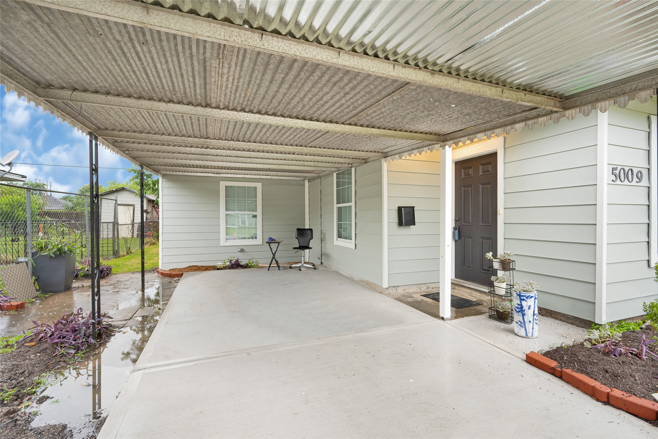 5009 Bataan Road Houston, TX 77033 - Photo 3 of 24 a view of a patio with table and chairs and wooden floor