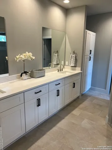 a bathroom with a shower a sink and a mirror