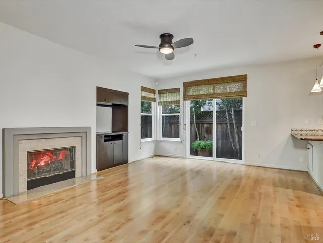 a view of an empty room with a fireplace and a window