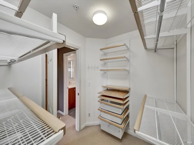 a view of walk in closet with empty racks