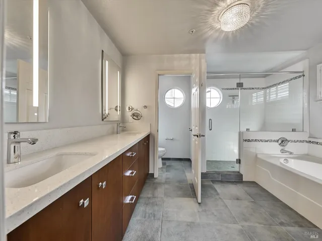 a spacious bathroom with a double vanity sink mirror double and bathtub
