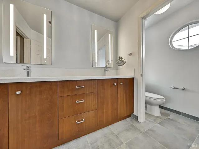 a bathroom with a toilet sink and mirror