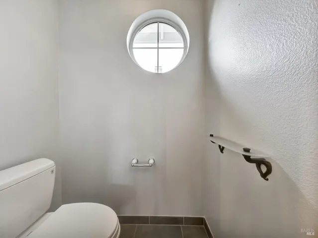 a bathroom with a toilet and a mirror