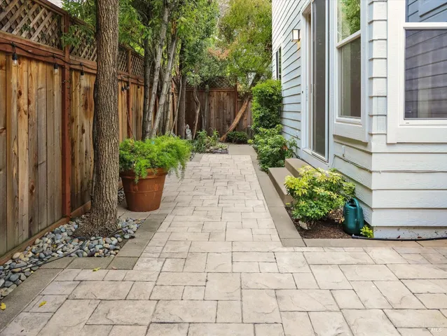 a view of a pathway with flower pots