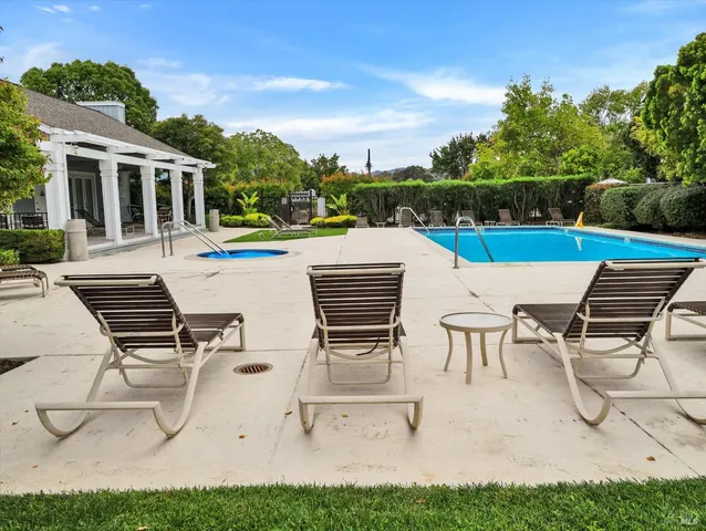 a view of a patio with table and chairs with wooden floor and fence