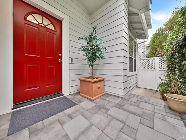 a backyard of a house with potted plants