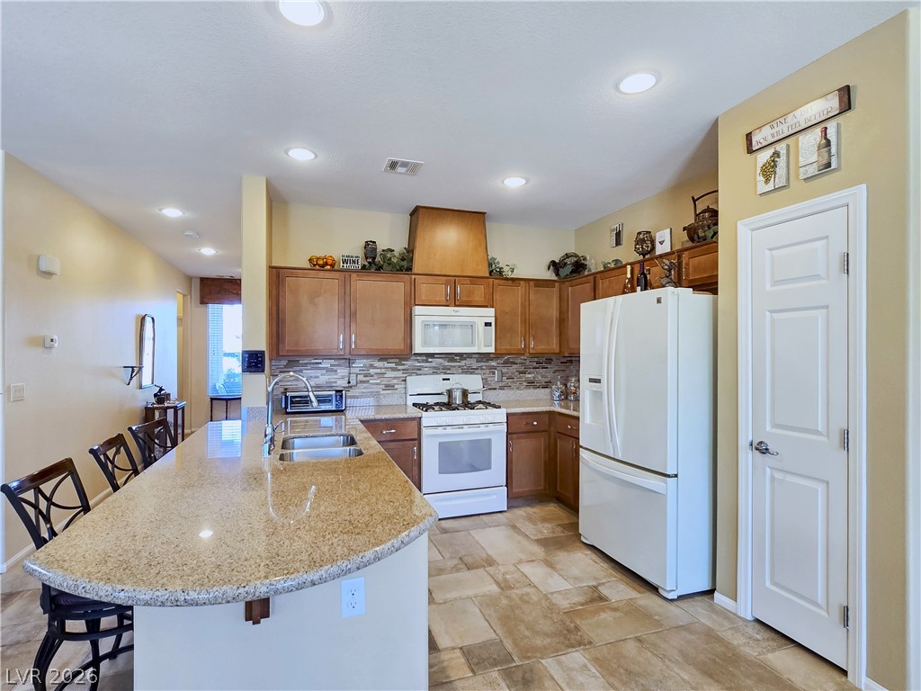 2485 Morrow Ridge Place Laughlin, NV 89029 - Photo 14 of 40 A well-appointed kitchen features ample counter space, rich wood cabinetry, and recessed lighting.