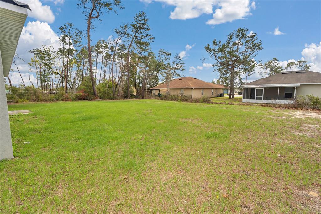 3650 Southwest 128th Place Ocala, FL 34473 - Photo 33 of 40 a house with a yard in front of it
