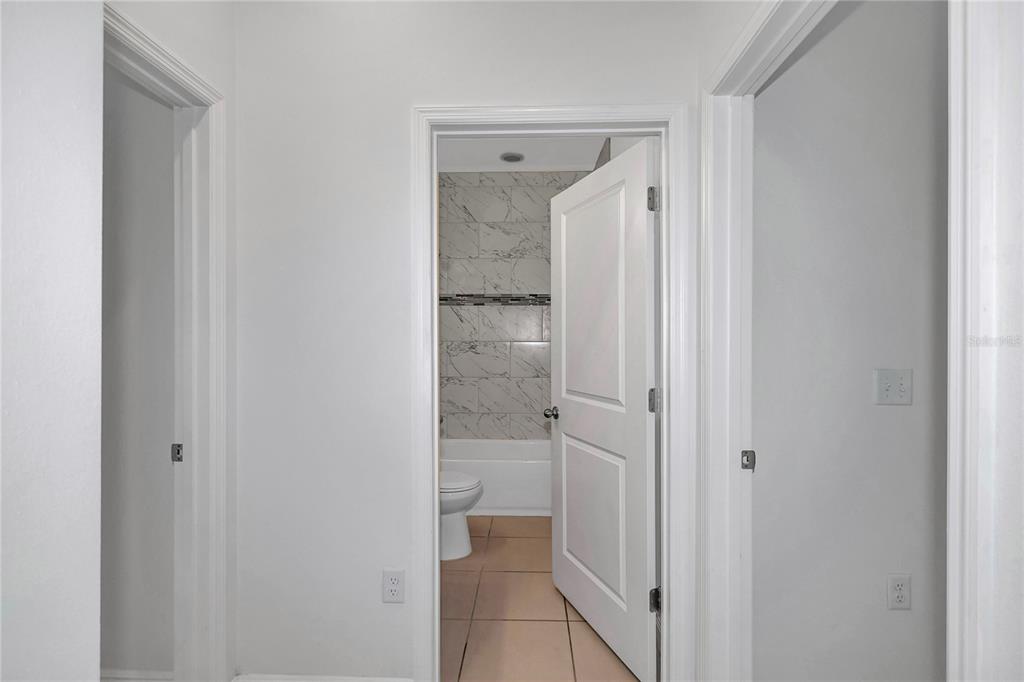 3650 Southwest 128th Place Ocala, FL 34473 - Photo 5 of 40 a bathroom with a glass shower door