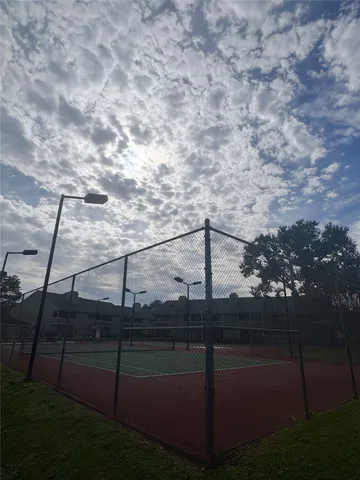 a swimming pool with outdoor seating and city view