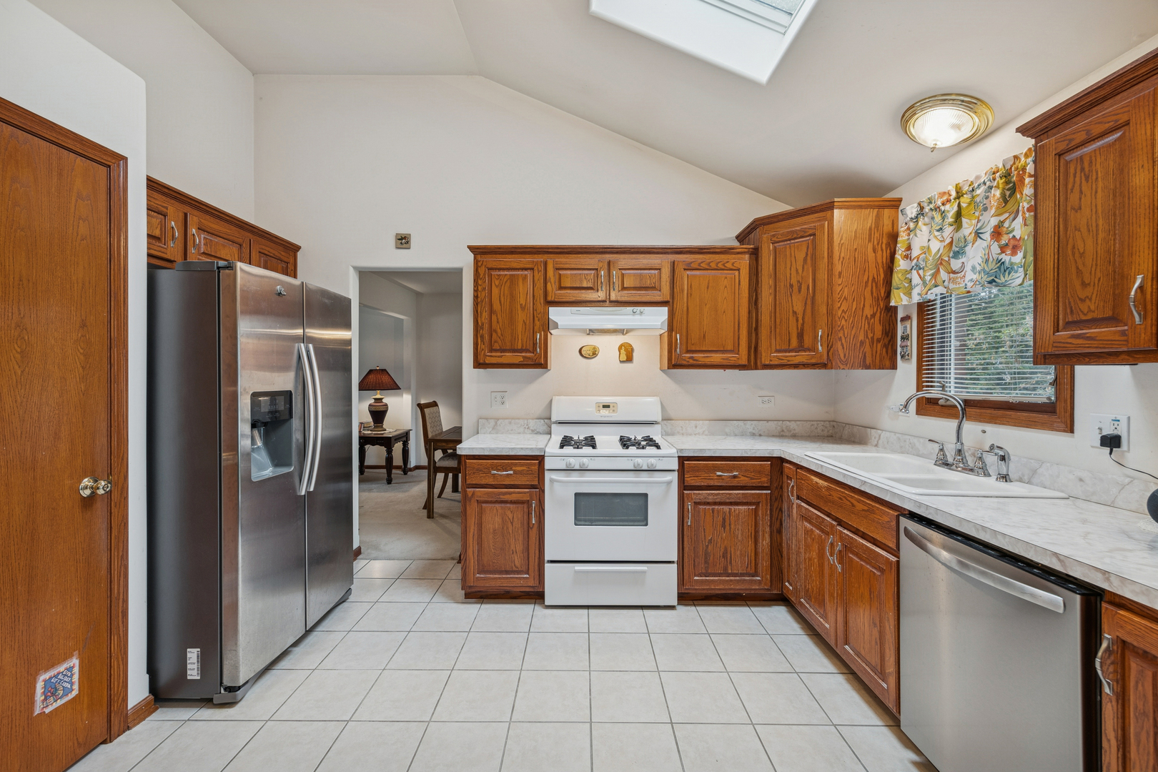 5524 Christopher Drive Oak Forest, IL 60452 - Photo 13 of 20 a kitchen with stainless steel appliances granite countertop a refrigerator sink and cabinets