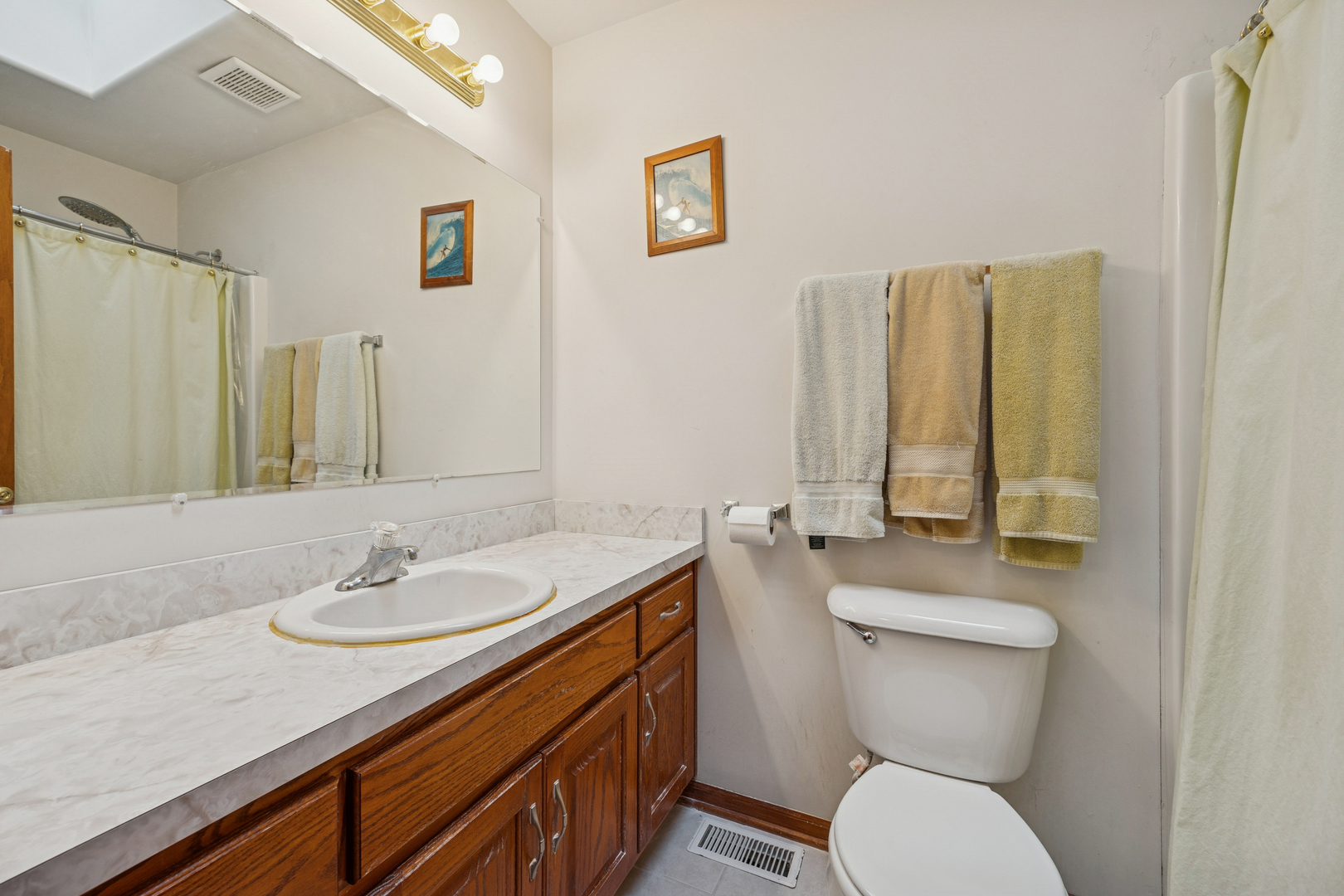 5524 Christopher Drive Oak Forest, IL 60452 - Photo 16 of 20 a bathroom with a granite countertop toilet sink and a mirror