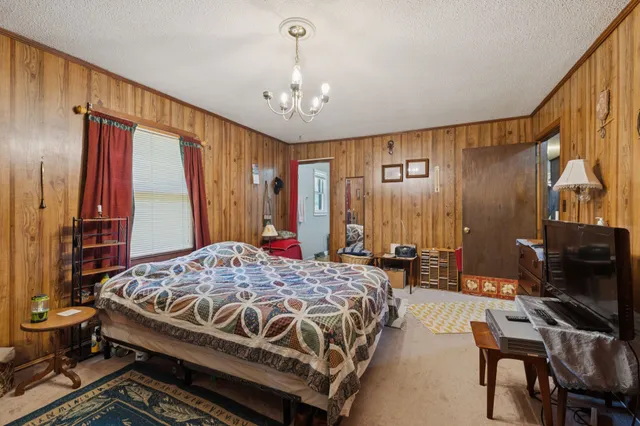 a bed sitting in a room next to a window