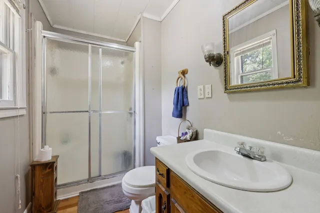 a bathroom with a sink toilet and shower