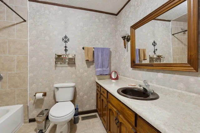 a bathroom with a sink a toilet and a mirror