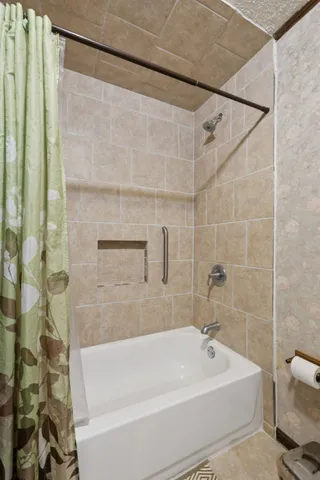 a bathroom with a shower and a bathtub