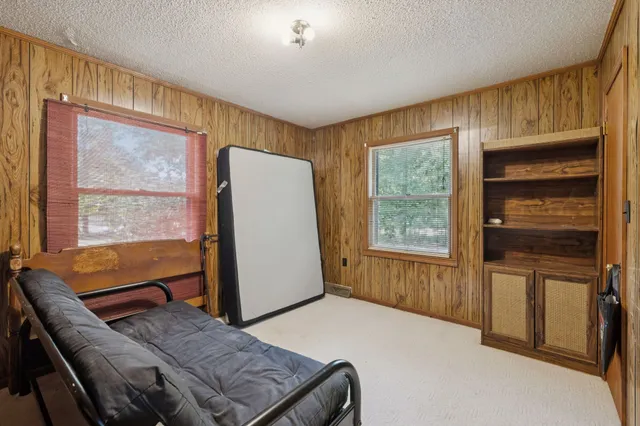 a living room with a bed furniture and a window