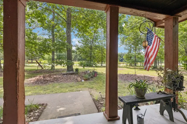 a view of a porch with furniture and garden
