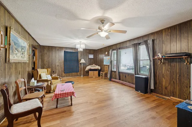 a living room with furniture a ceiling fan and a window