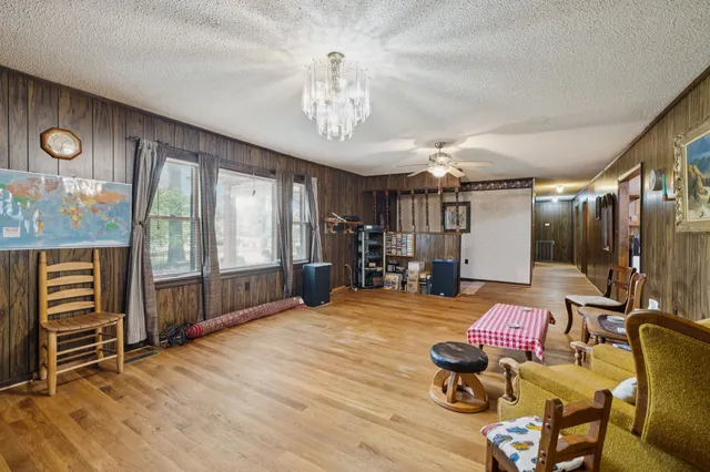 a bedroom with furniture and a chandelier