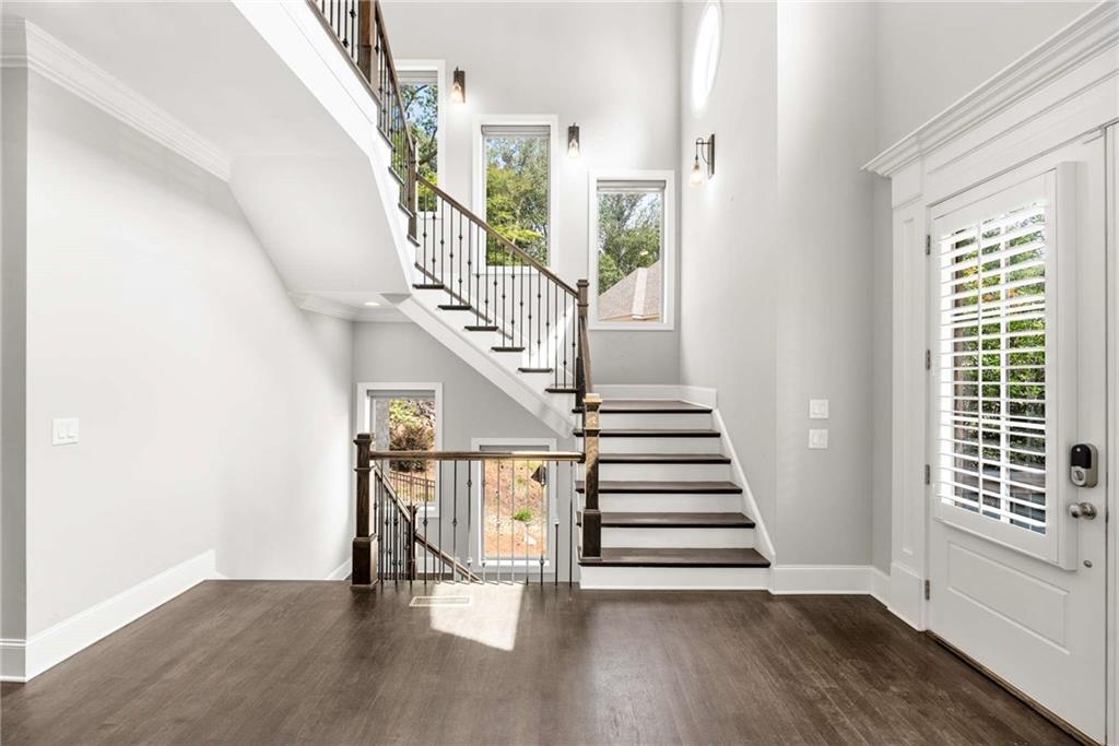 5055 Pointer Ridge Flowery Branch, GA 30542 - Photo 11 of 79 a view of entryway and hall with wooden floor