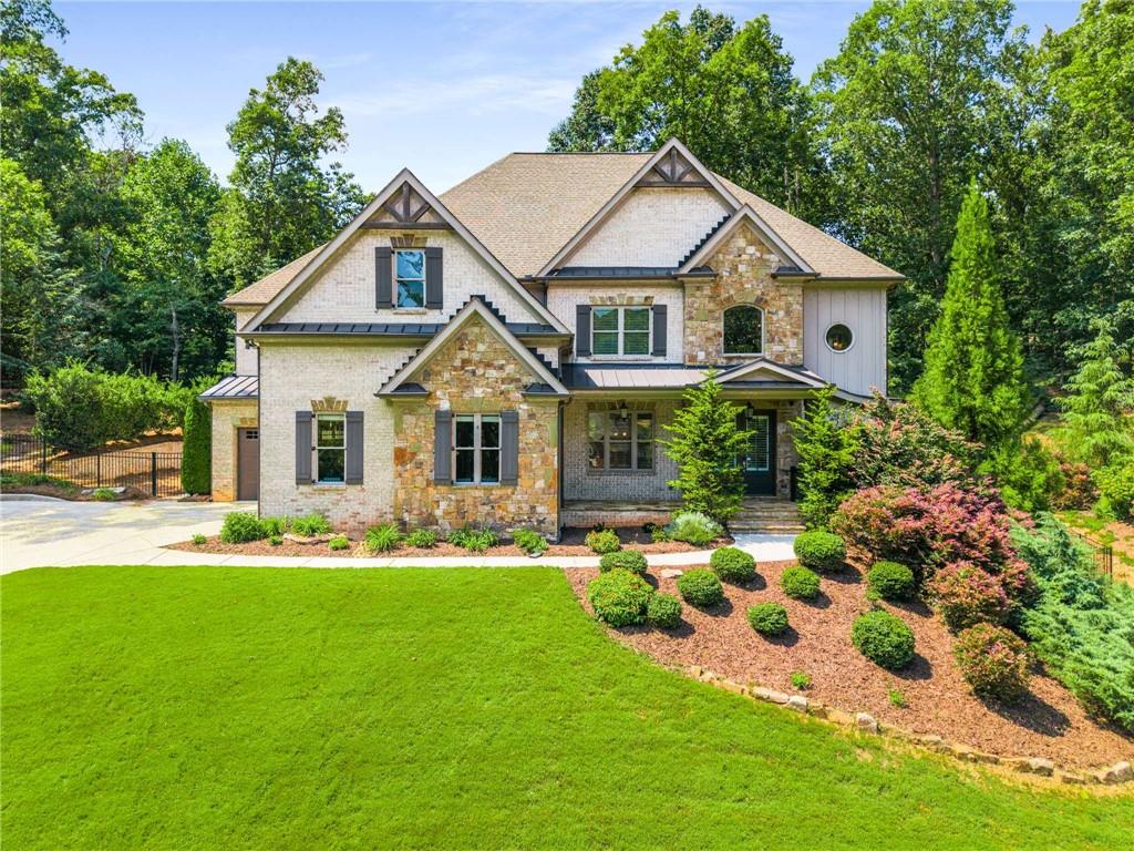 5055 Pointer Ridge Flowery Branch, GA 30542 - Photo 2 of 79 a view of house with garden and tall trees