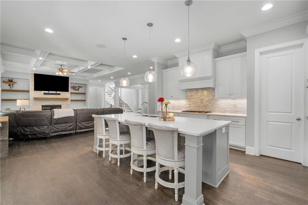 5055 Pointer Ridge Flowery Branch, GA 30542 - Photo 21 of 86 a large kitchen with a table and chairs