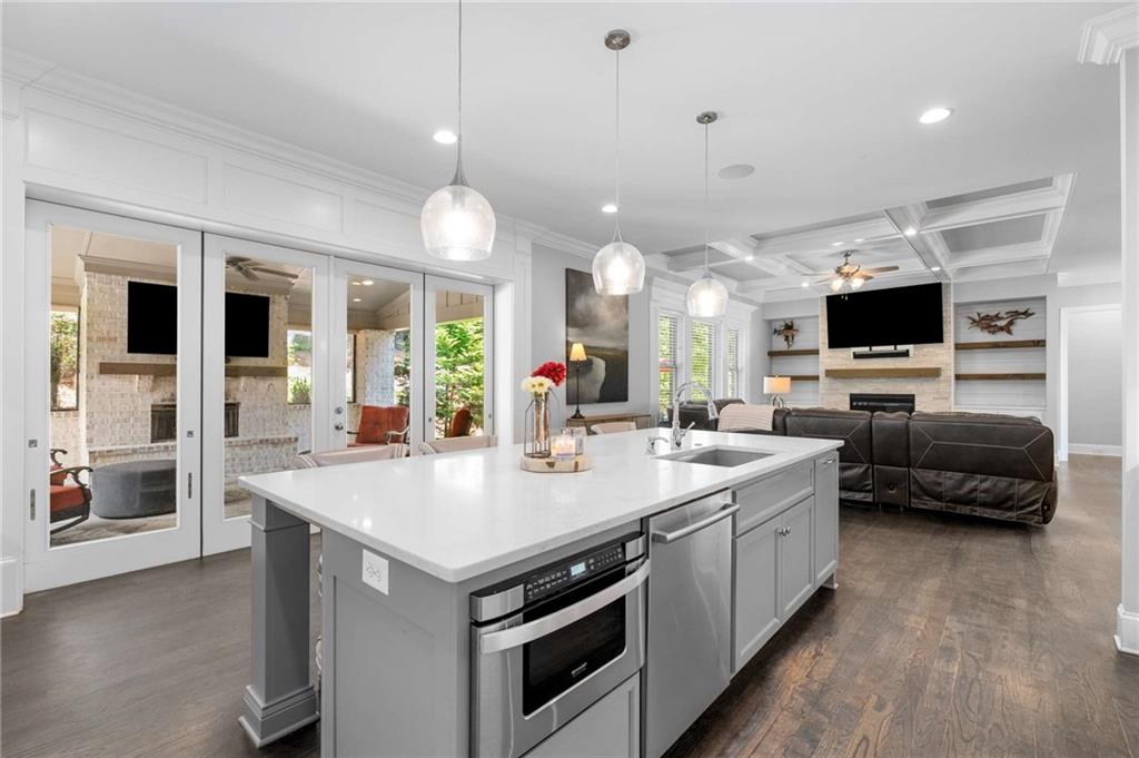 5055 Pointer Ridge Flowery Branch, GA 30542 - Photo 22 of 86 a large white kitchen with a stove and a large window