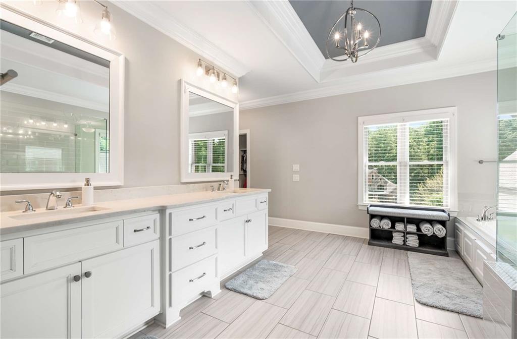 5055 Pointer Ridge Flowery Branch, GA 30542 - Photo 30 of 79 a large bathroom with a large tub and sink