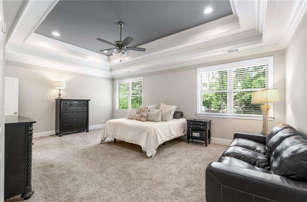 5055 Pointer Ridge Flowery Branch, GA 30542 - Photo 33 of 86 a spacious bedroom with a bed and a couch