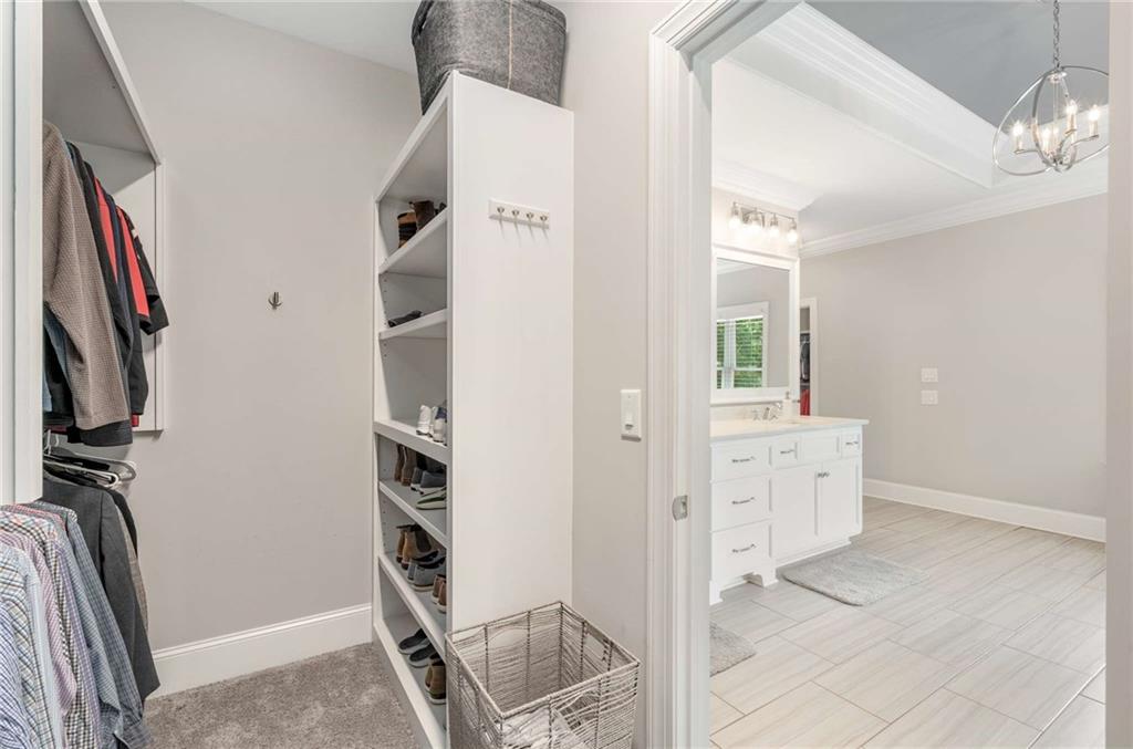 5055 Pointer Ridge Flowery Branch, GA 30542 - Photo 34 of 79 a view of walk in closet with clothes and shoes