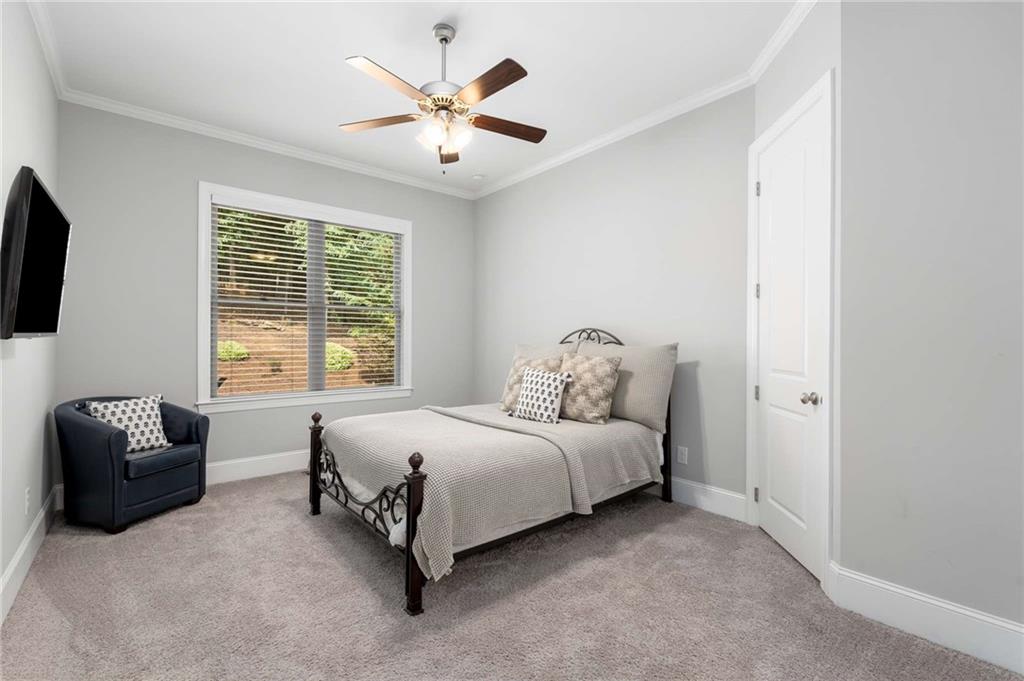 5055 Pointer Ridge Flowery Branch, GA 30542 - Photo 35 of 79 a spacious bedroom with a bed and a couch