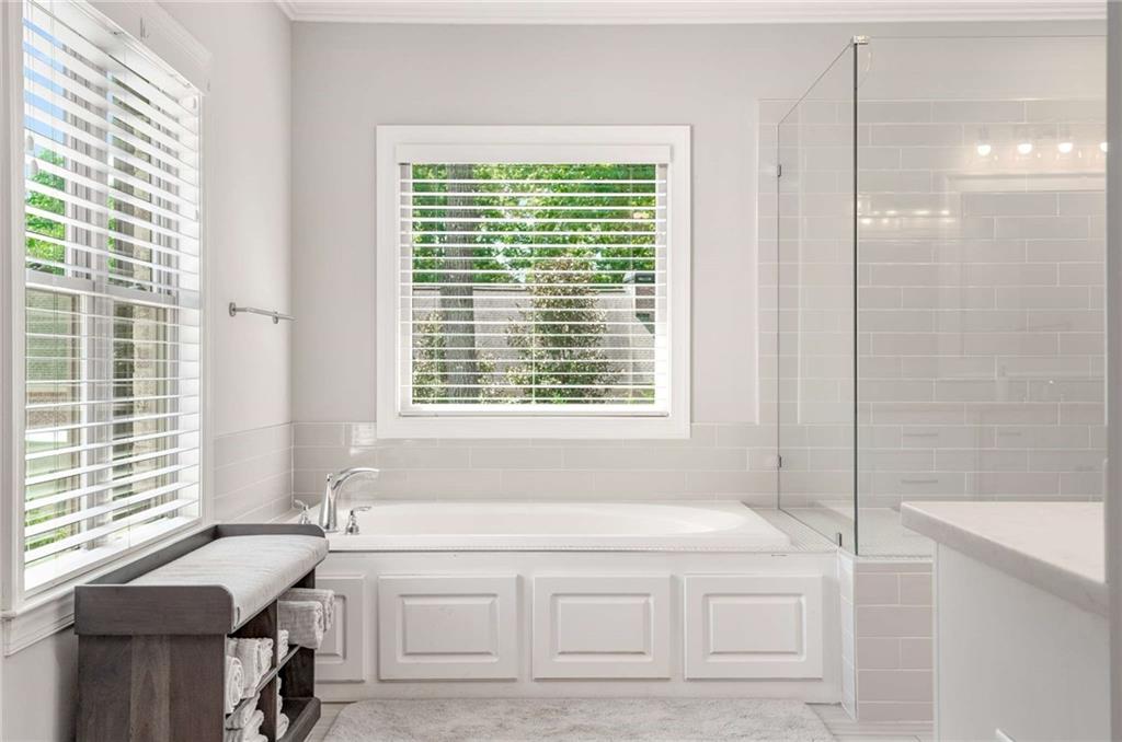 5055 Pointer Ridge Flowery Branch, GA 30542 - Photo 38 of 86 a bathroom with a bathtub and a window