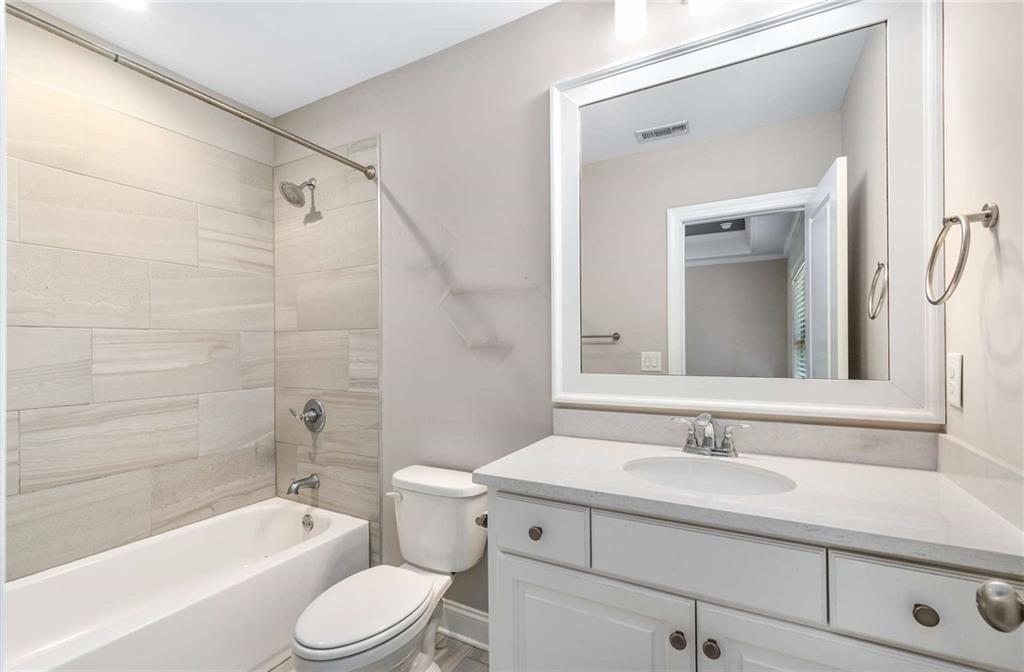 5055 Pointer Ridge Flowery Branch, GA 30542 - Photo 42 of 79 a bathroom with a sink toilet a bathtub and shower