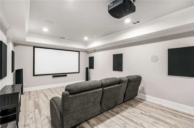 an aerial view of residential houses with outdoor space and trees