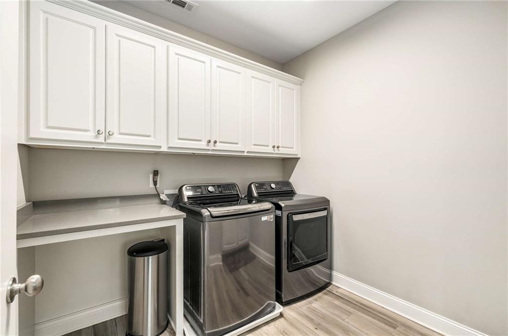 5055 Pointer Ridge Flowery Branch, GA 30542 - Photo 49 of 86 a kitchen with stainless steel appliances granite countertop a stove and a white cabinets