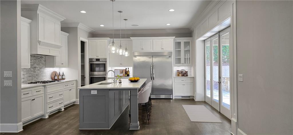 5055 Pointer Ridge Flowery Branch, GA 30542 - Photo 5 of 86 a kitchen with counter top space cabinets and stainless steel appliances