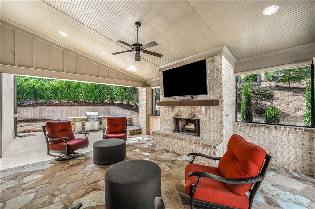 5055 Pointer Ridge Flowery Branch, GA 30542 - Photo 52 of 79 a living room with furniture a fireplace and a flat screen tv