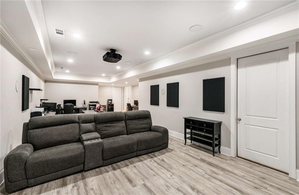 5055 Pointer Ridge Flowery Branch, GA 30542 - Photo 54 of 86 a living room with furniture and a flat screen tv