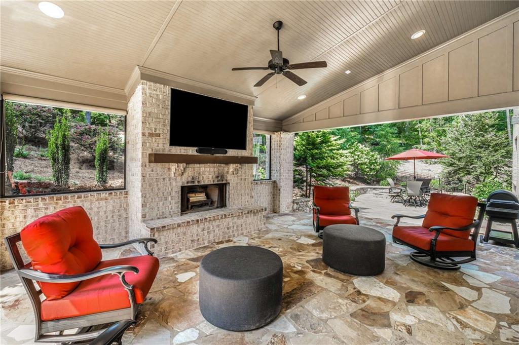 5055 Pointer Ridge Flowery Branch, GA 30542 - Photo 7 of 79 a living room with furniture a flat screen tv and a fireplace