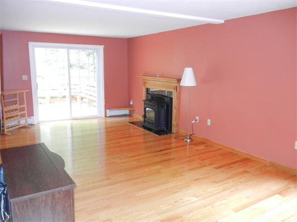 42 Clark Road Sturbridge, MA 01518 - Photo 10 of 19 a view of empty room with fireplace and wooden floor