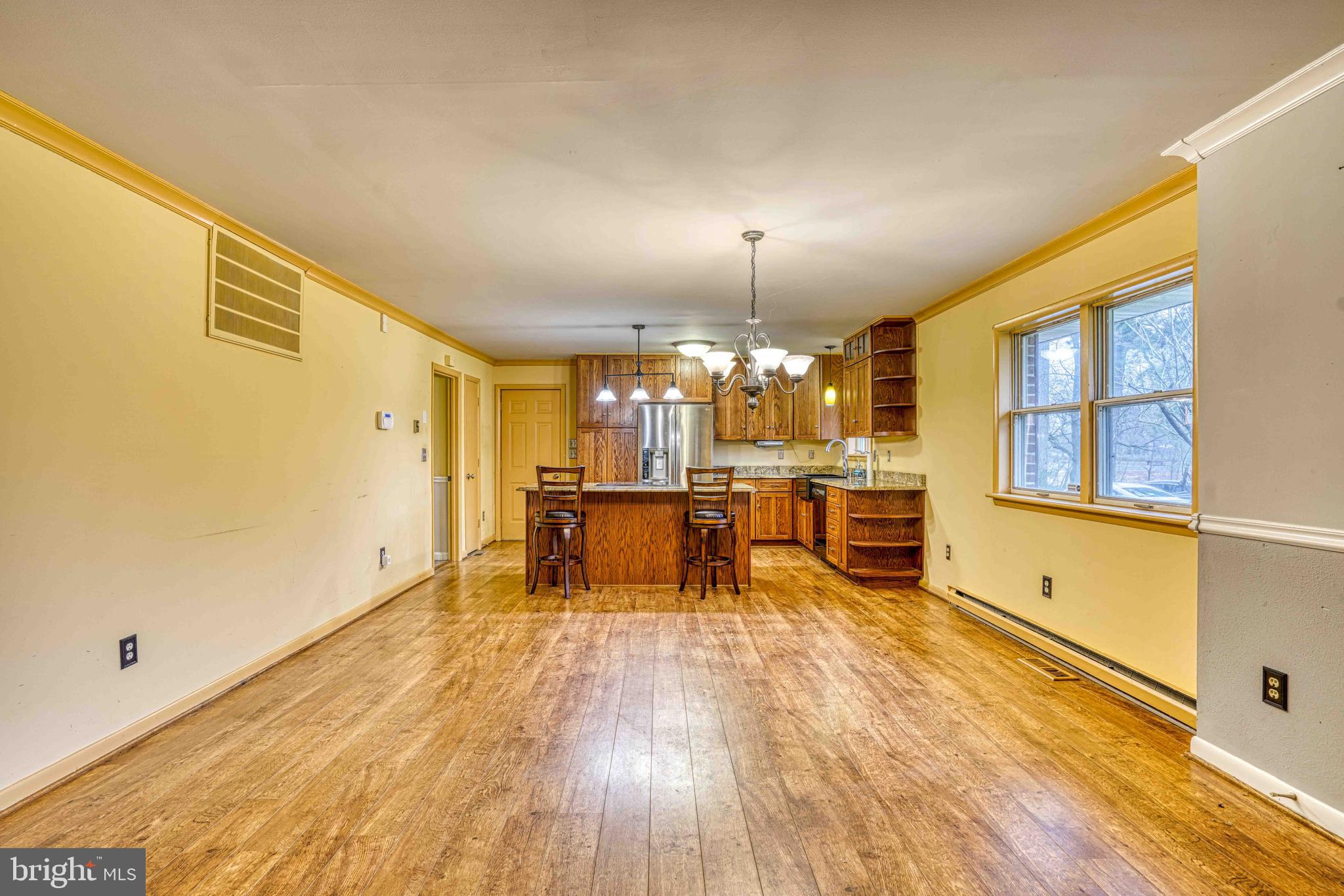 14957 Cherry Lane Ridgely, MD 21660 - Photo 15 of 66 a view of a living room a dining room with furniture and wooden floor