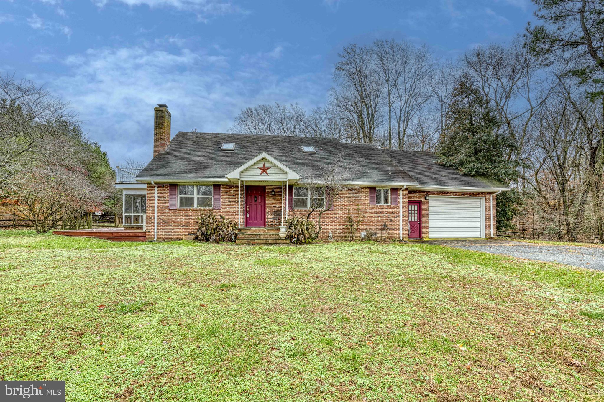 14957 Cherry Lane Ridgely, MD 21660 - Photo 2 of 66 a front view of a house with a yard and garage