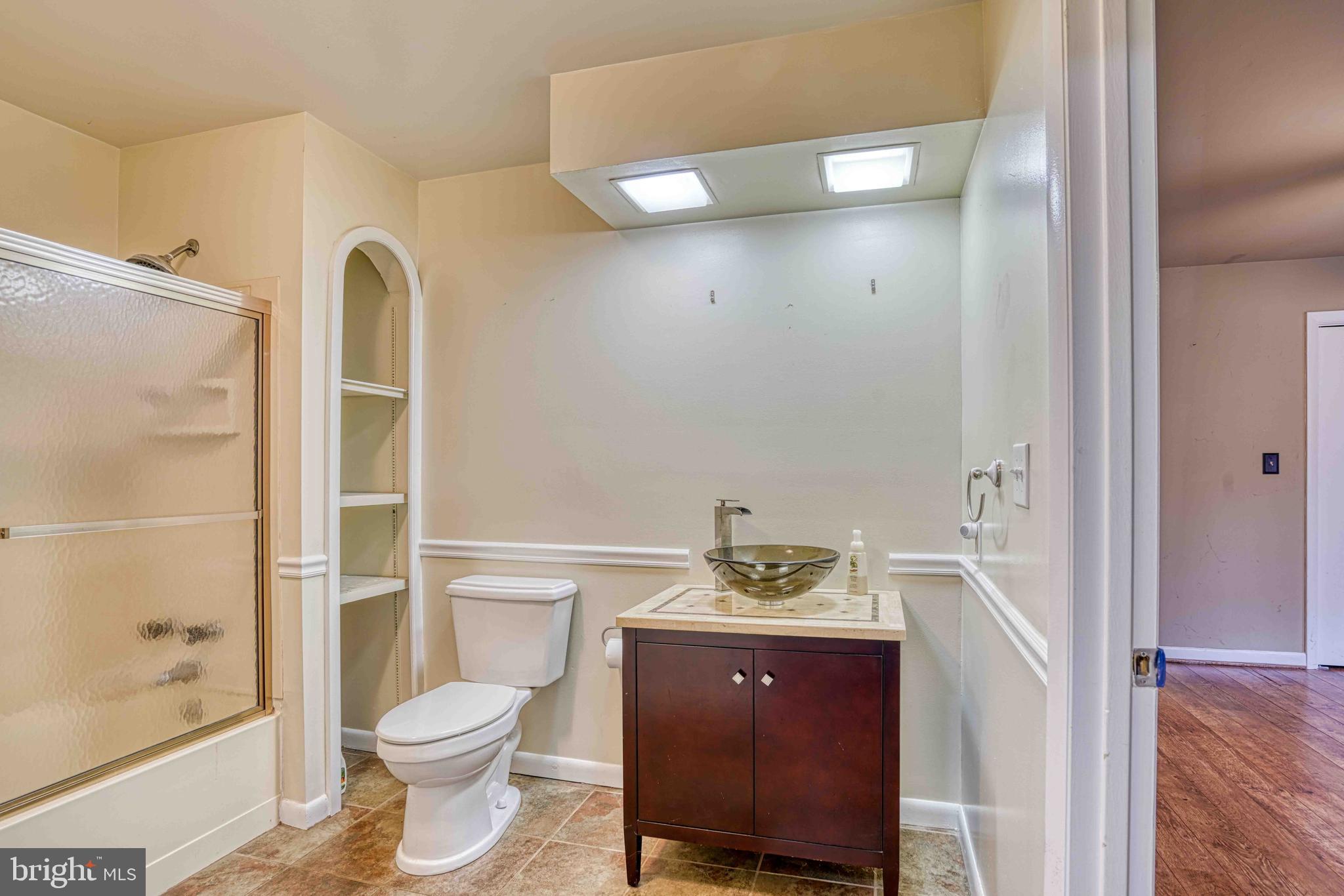 14957 Cherry Lane Ridgely, MD 21660 - Photo 22 of 66 a bathroom with a sink a toilet and shower