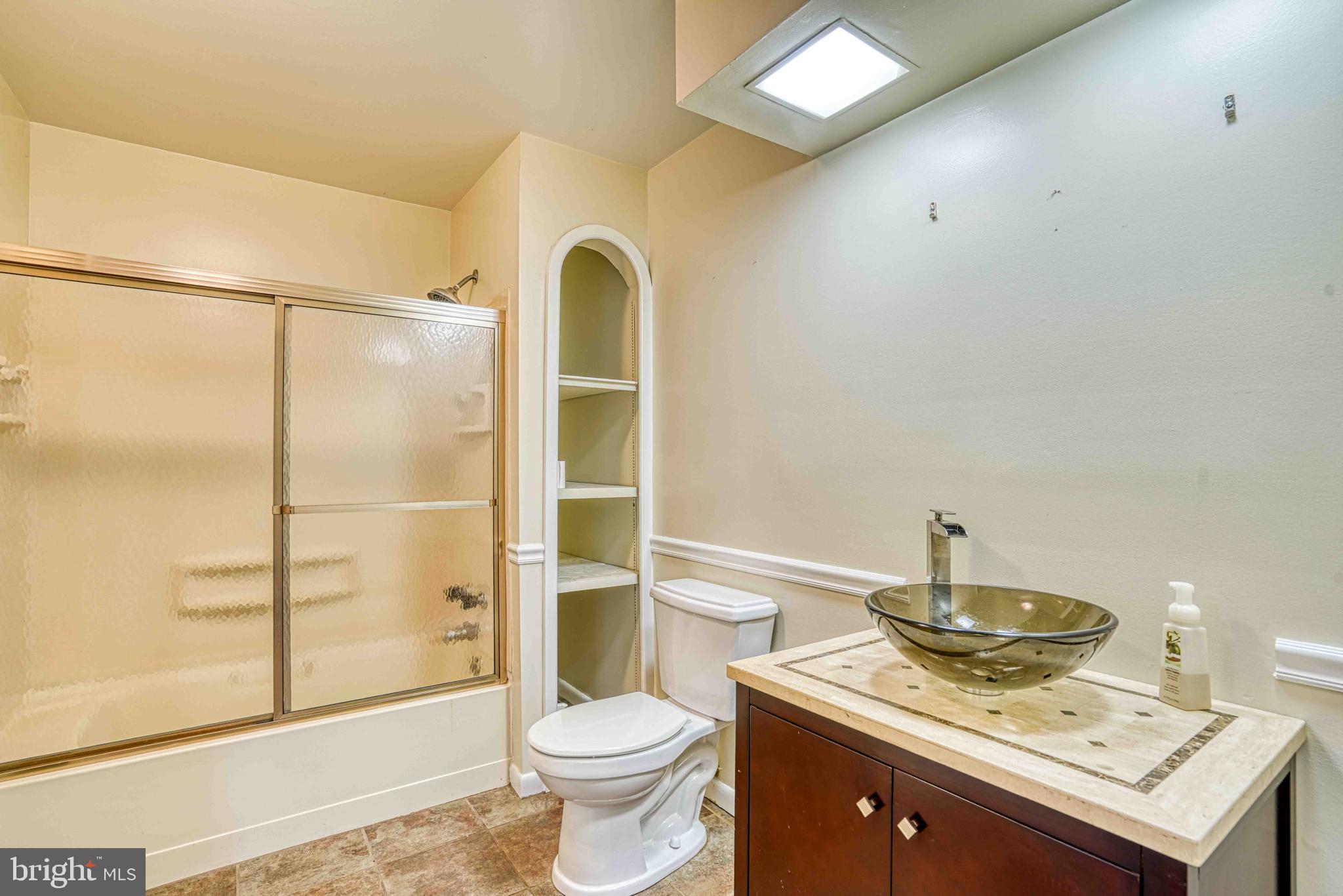 14957 Cherry Lane Ridgely, MD 21660 - Photo 23 of 66 a bathroom with a sink toilet and shower